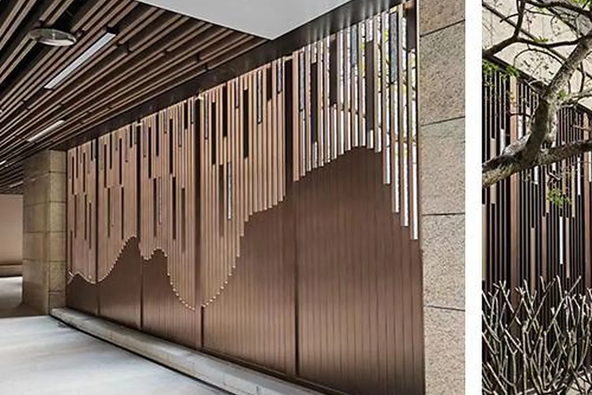 Bronze-tone decorative metal screens in a landscaped residential walkway