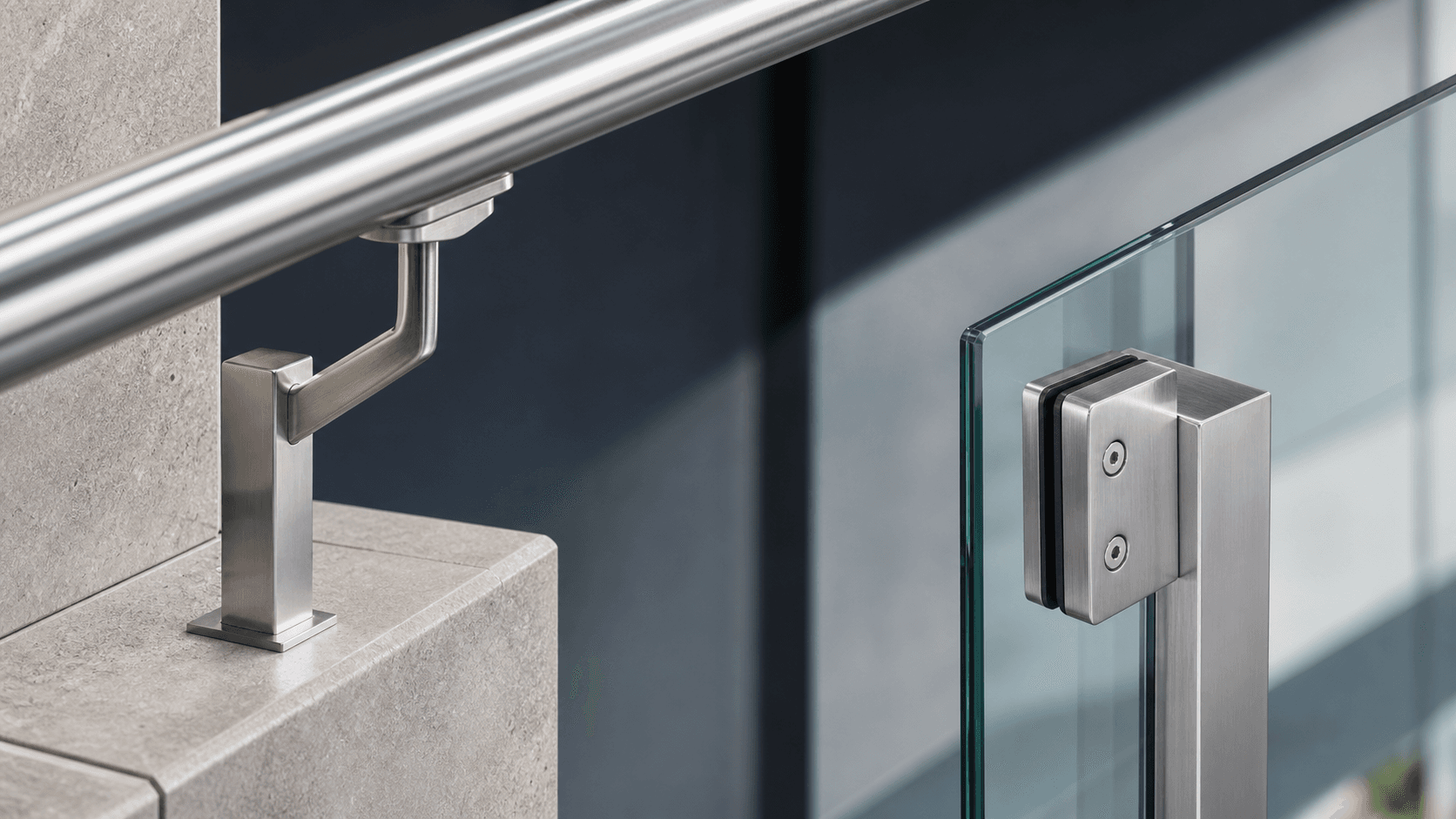 Close-up comparison of a stainless steel handrail bracket and a glass clamp